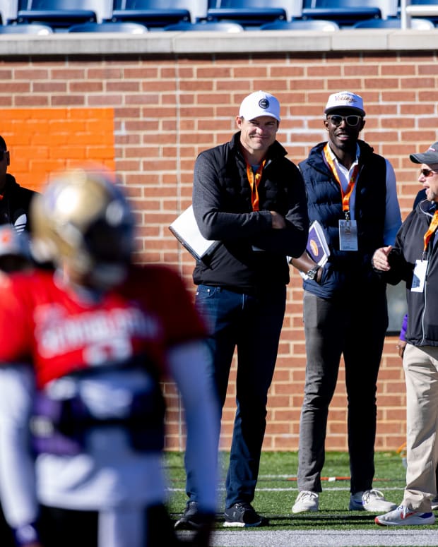 Kevin O'Connell and Kwesi Adofo-Mensah watch quarterback Michael Penix Jr. at the Senior Bowl in Mobile, Alabama.